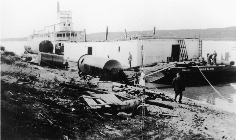 Unloading a barge at Bitumount, late 1930s