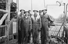 Although this oil rig crew is from a well near Verdun, Manitoba, it shows the typical size and dress of oil rig crews throughout Western Canada in the 1950s. Although improvements in dress and safety equipment had been made since the birth of the oil patch (note the hardhats and overalls), there was little in the way of safety or labour standards.
