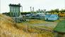 The absorption plant (left), gasoline and propane plants (centre), and lean oil pump house (right) ca. 2002; the green roof of the electrical shop is visible in the foreground. <br />Source: Alberta Culture and Tourism