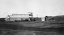 Absorption plant, under construction at the Royalite gas plant, Turner Valley, Alberta, ca. 1921; note that portions at either end of the building were later removed, leaving the building that remains today. <br />Source: Glenbow Archives IP-6e-5-3