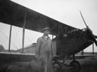 A. B. King, manager for the Union Bank of Canada at Okotoks, stands in front of an airplane just before takeoff to Black Diamond, Alberta, 1923. Weekly service and pay day service was supplied for Imperial Oil’s staff at Turner Valley/Black Diamond, Alberta. <br />Source: Glenbow Archives, NA-4447-5