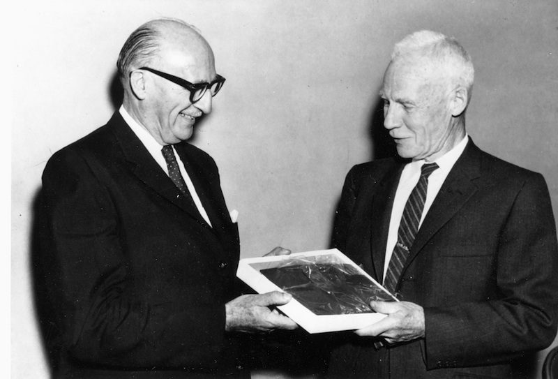 Sidney Blair (left) presents Karl Clark with a commemorative copy of the book of essays on the oil sands produced in his honour in 1963.