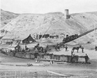 The coal transfer area in the valley near early Coalbanks in the late 1890s; the pipe lying on the slope brought compressed air.<br/>Source: Galt Museum & Archives