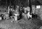 Interior view of an early blacksmith shop south of Red Deer
