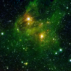 The greenish mist seen here is comprised of hydrogen and carbon molecules called polycyclic aromatic hydrocarbons (PAHs), which are also found on Earth in vehicle exhaust and on charred grills. Source: Courtesy NASA/JPL-Caltech/2MASS/SSI/UniversityofWisconsin