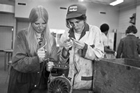 Two women work on an engine in a metal shop, Calgary, 1977. By the end of the 1970s, opportunities for women in the trades were beginning to open up. Some women trained in trades such as welding, mechanics and machining and found employment in the oil sector. When this photograph ran in the February 22, 1977, edition of the <em>Calgary Herald</em>, however, it was reported that finding women engaged in such work was "something of an oddity."