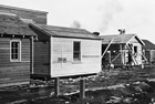 These small, rudimentary,  mass-produced homes for oil-field workers and their families in the oil-field community of Royalites (also known as "Little Chicago") were preferable to the shanties in which many oil-patch employees were living.<br/>Source: Glenbow Archives, NA-2895-14