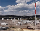 This 1977 view shows the northern part of the Turner Valley gas plant. The large boiler house has been demolished; its function was replaced by a new facility constructed in 1963 on the far end of the 1952 sulfur plant, at right. That same year a propane plant was moved onto the site and added to the gasoline plant building. Two features that have been removed since this photograph was taken are the flare stack at centre, in the distance, and the very tall stack next to the sulfur plant at right. <br />Source: Alberta Culture and Tourism